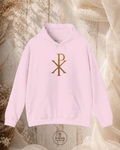 Pink hoodie with gold symbol on a textured background