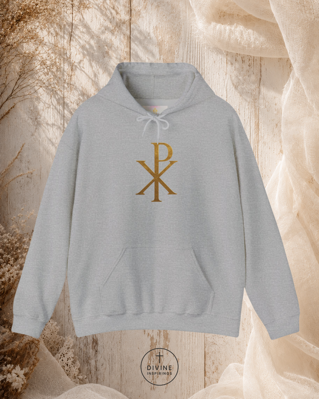 Gray hoodie with a gold symbol on a textured beige background