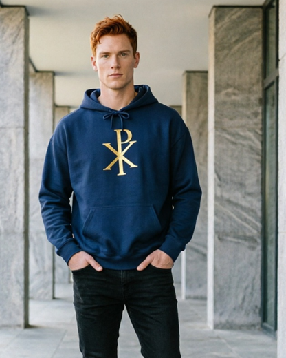 Man wearing a navy hoodie with a gold logo in an indoor setting