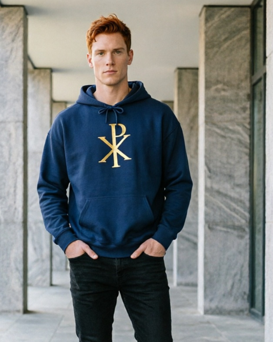 Man wearing a navy hoodie with a gold logo in an indoor setting