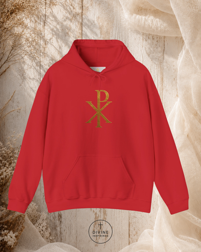 Red hoodie with gold symbol on a textured beige background