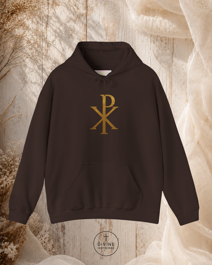 Black hoodie with gold symbol on a textured beige background
