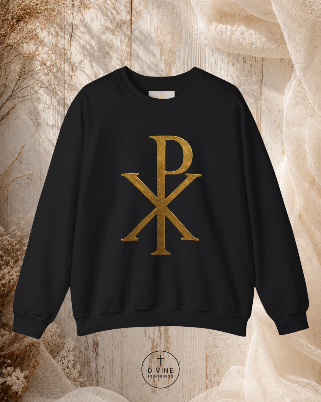 Black sweatshirt with gold symbol on a textured beige background