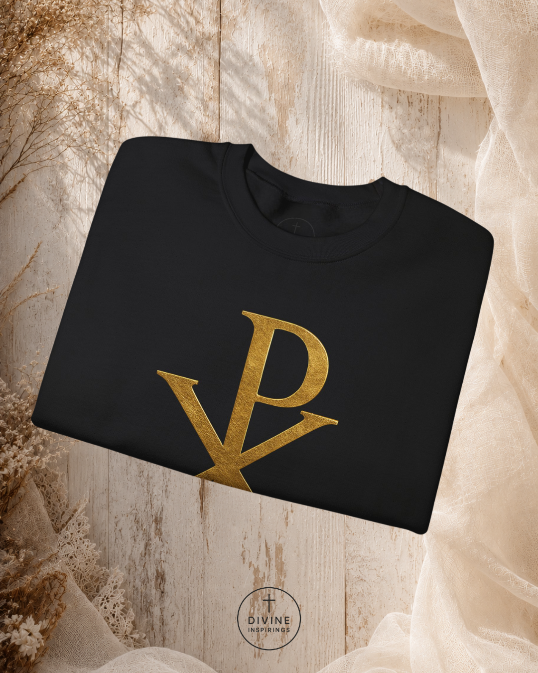 Black sweatshirt with gold logo on a textured beige background