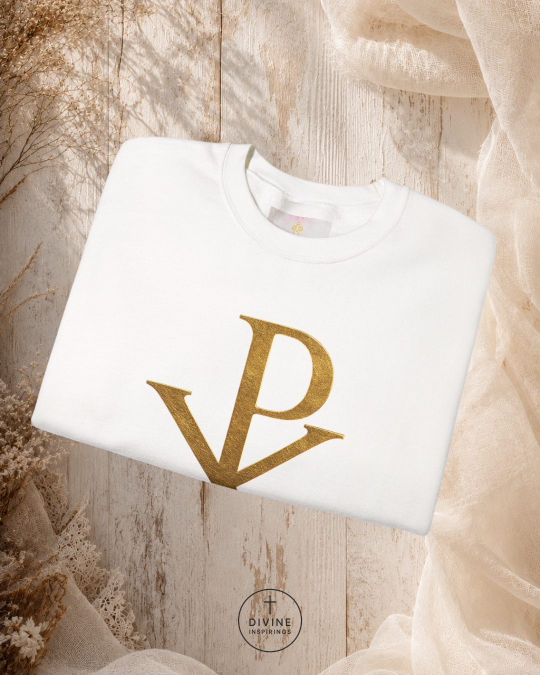 White sweatshirt with gold logo on a textured beige background