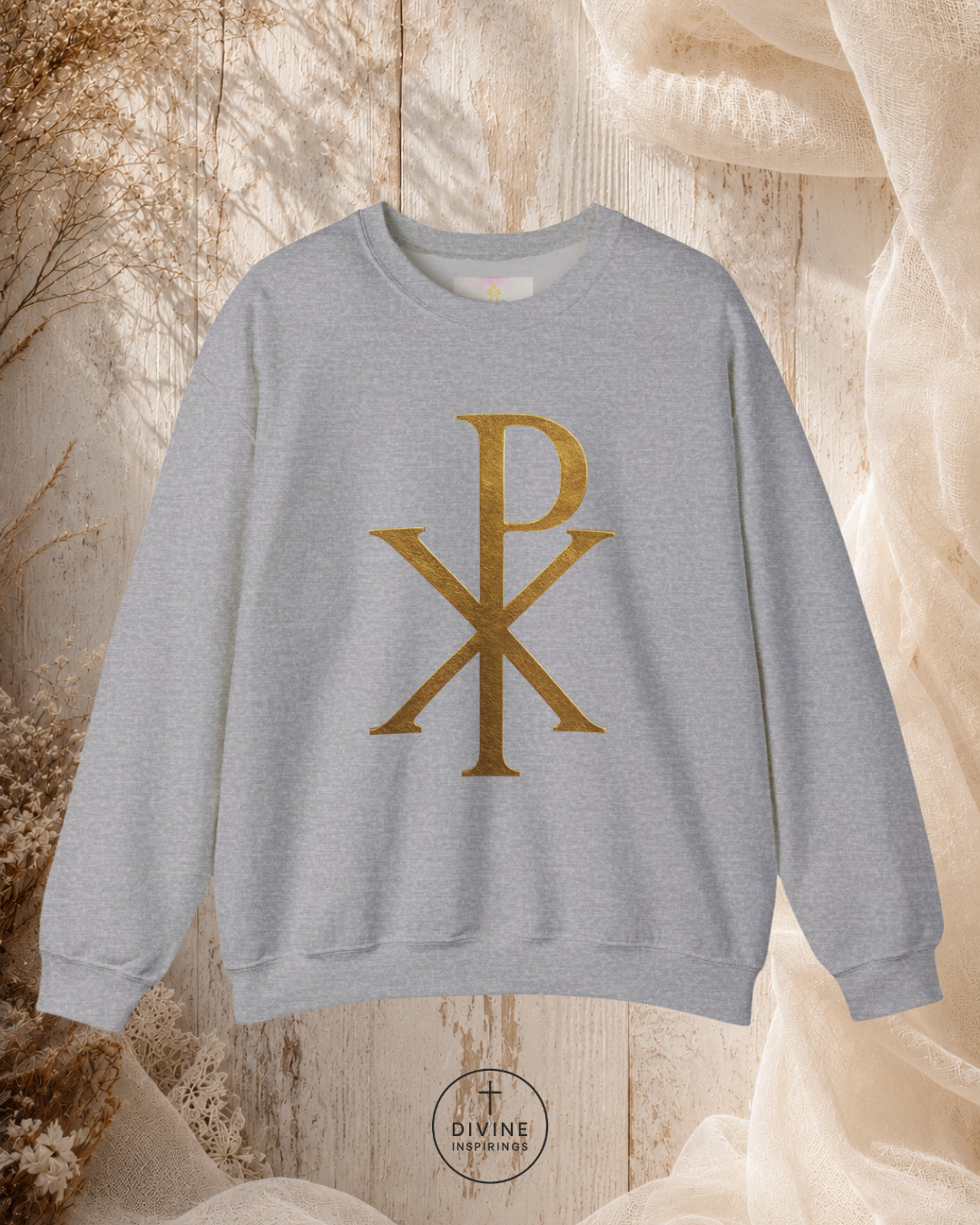 Gray sweatshirt with gold symbol on a textured beige background