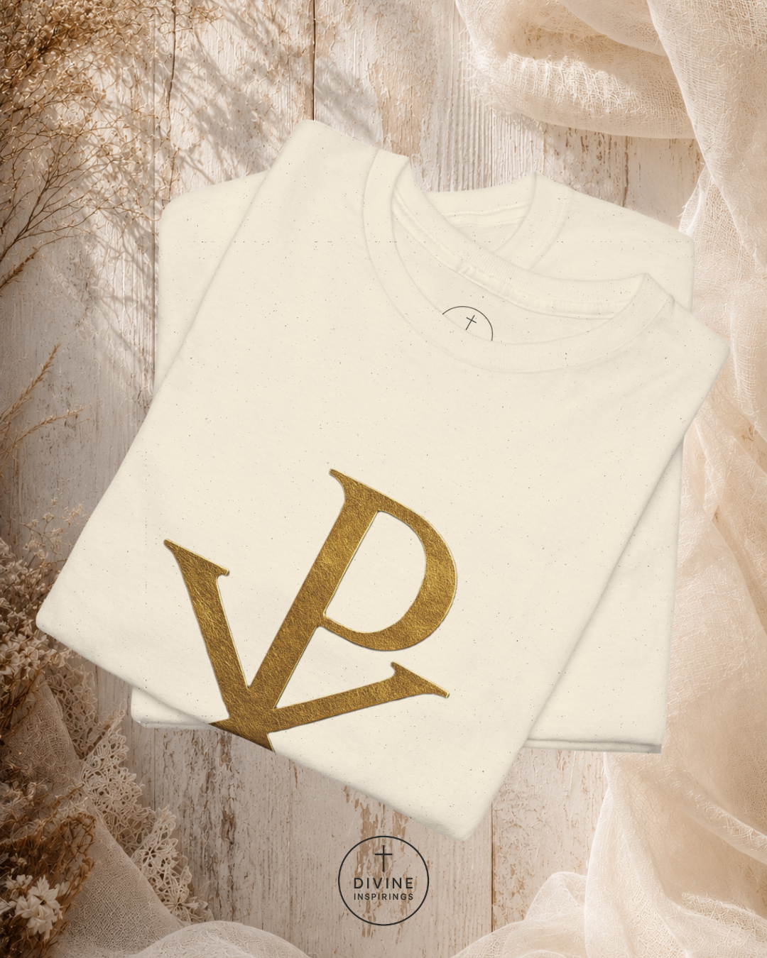 White sweatshirt with gold 'DP' logo on a wooden surface