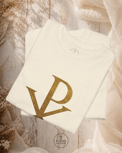 White sweatshirt with gold 'DP' logo on a wooden surface