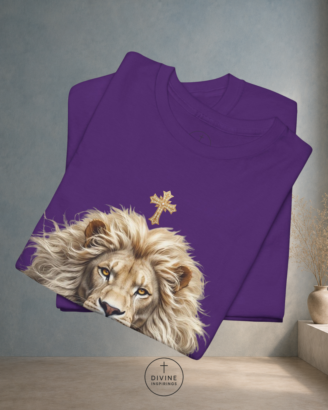 Folded purple sweatshirt with a lion and cross design on a gray background