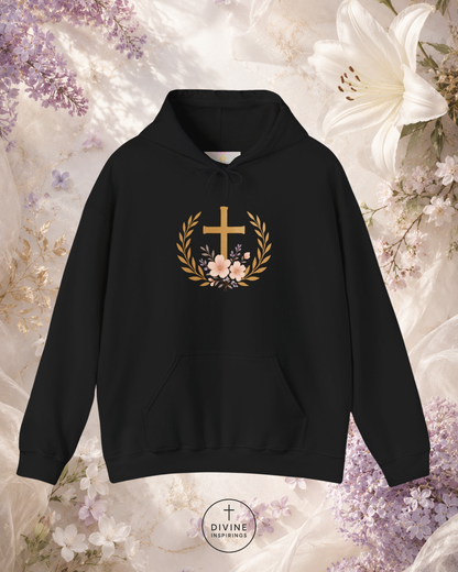 Black hoodie with a gold cross and floral wreath design on a floral background