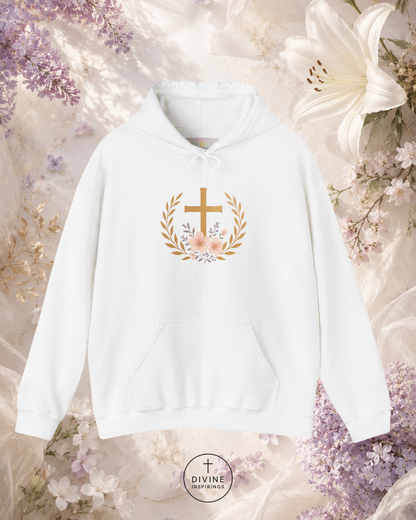 White hoodie with a gold cross and floral design on a floral background