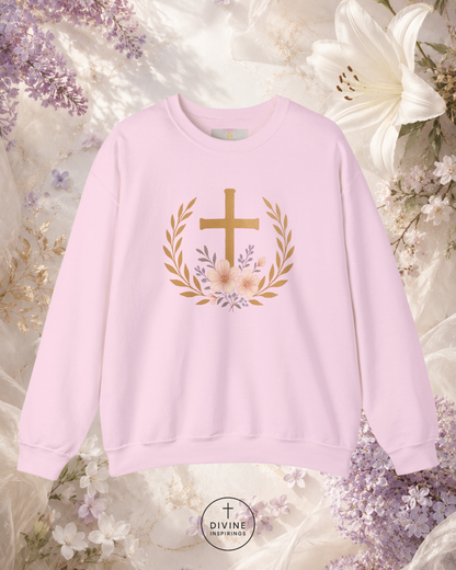 Pink sweatshirt with a gold cross and floral design on a floral background