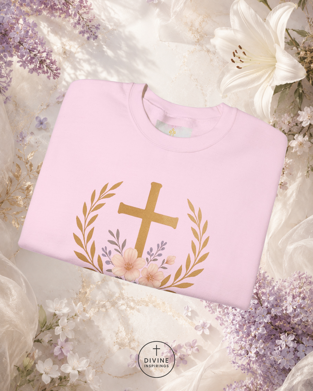 Pink sweatshirt with gold cross design on a floral background