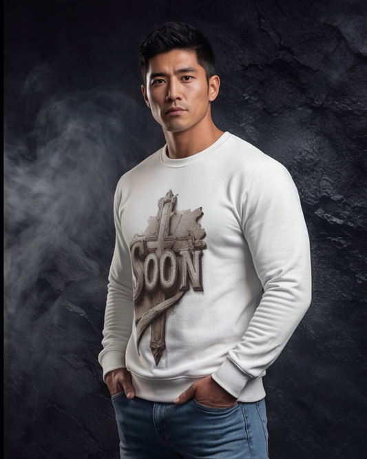 Man wearing a white sweatshirt with a graphic design on a dark background