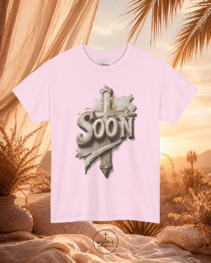 Pink t-shirt with 'SOON' graphic design against a desert sunset background