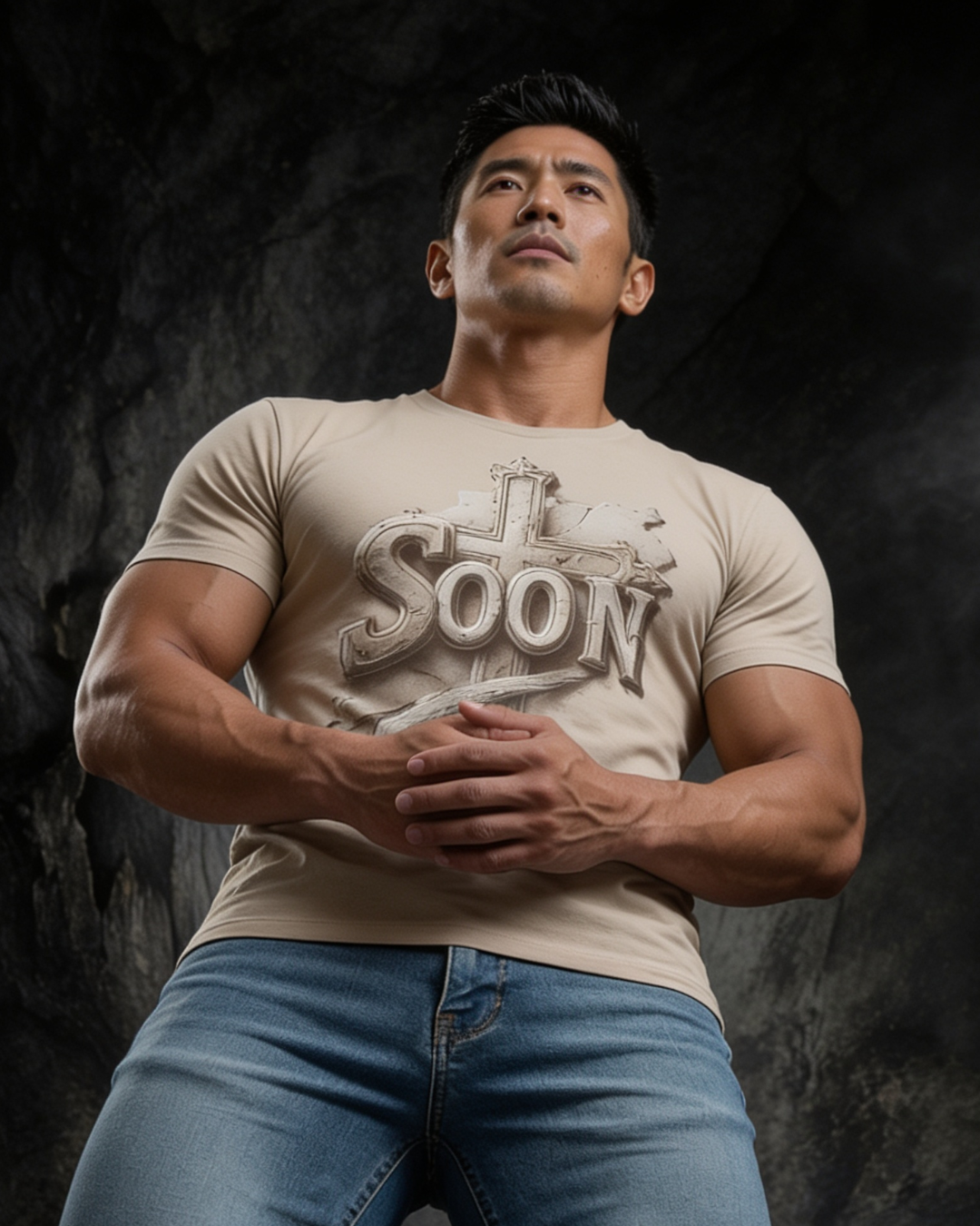 Man wearing a beige t-shirt with 'I'll be there soon' text against a dark background