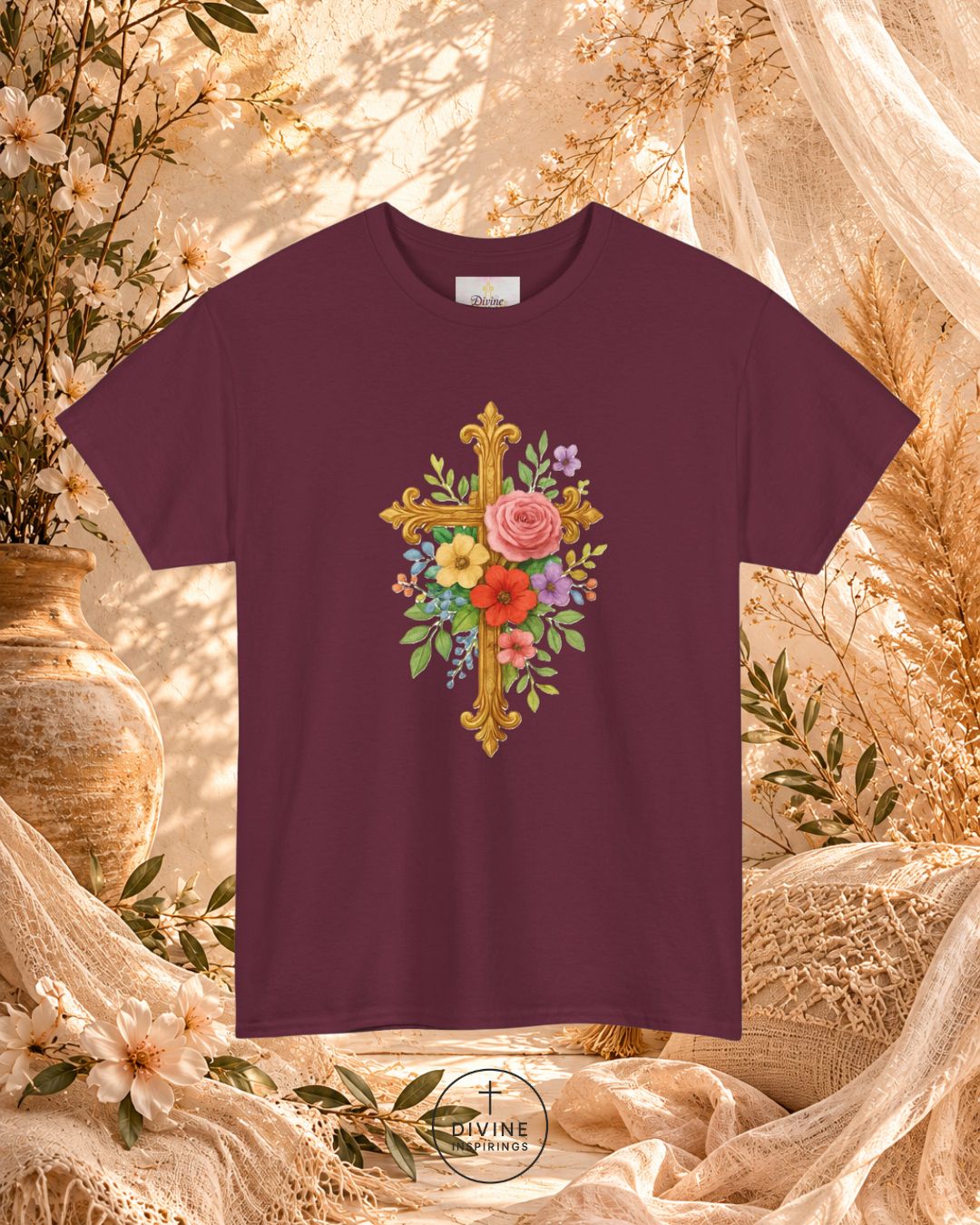 Maroon t-shirt with floral cross design on a decorative background