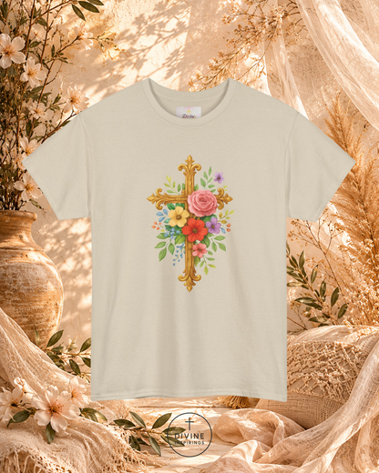Beige t-shirt with floral cross design on a decorative background with flowers and fabric.