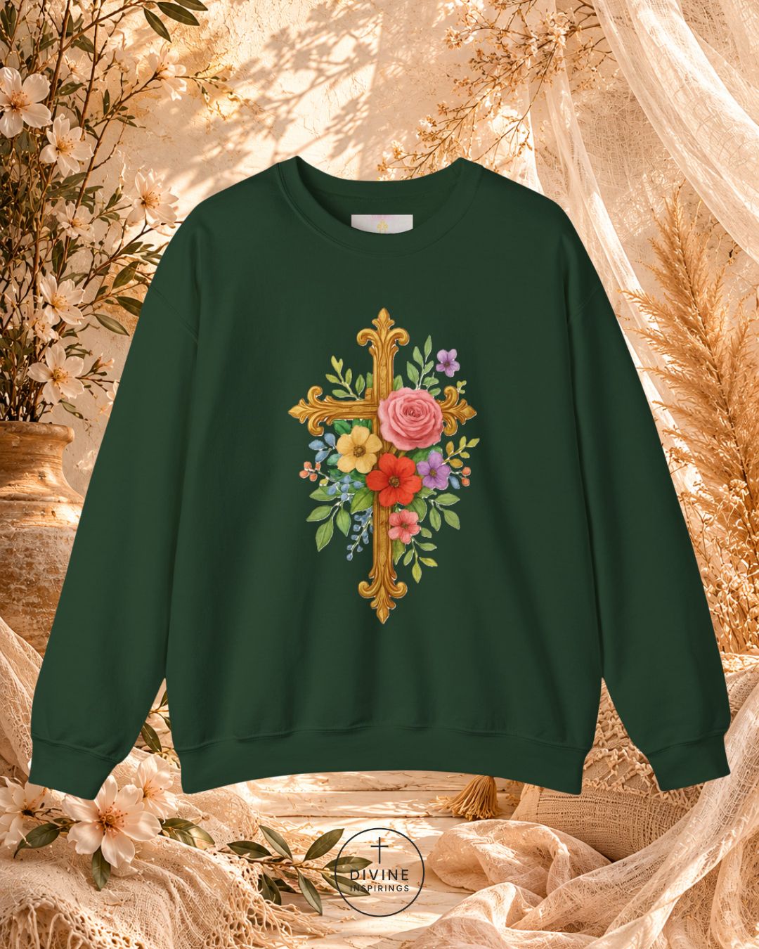 Green sweatshirt with floral cross design on a decorative background
