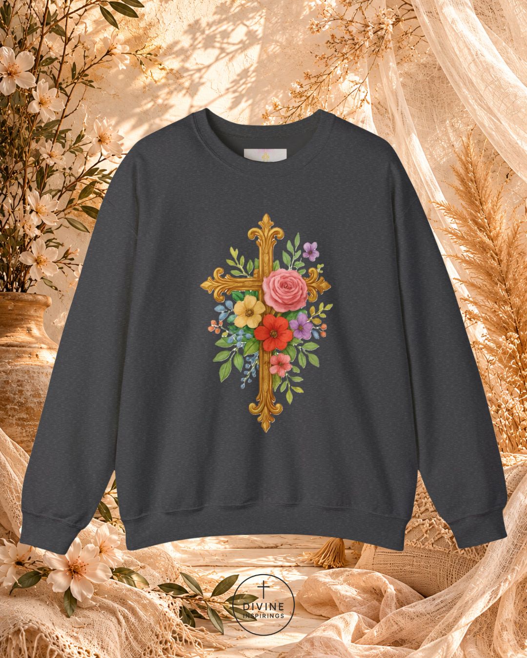 Dark gray sweatshirt with floral cross design on a decorative background