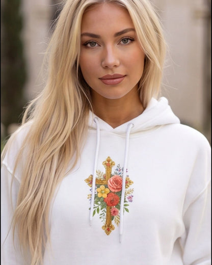 Woman wearing a white hoodie with floral cross design