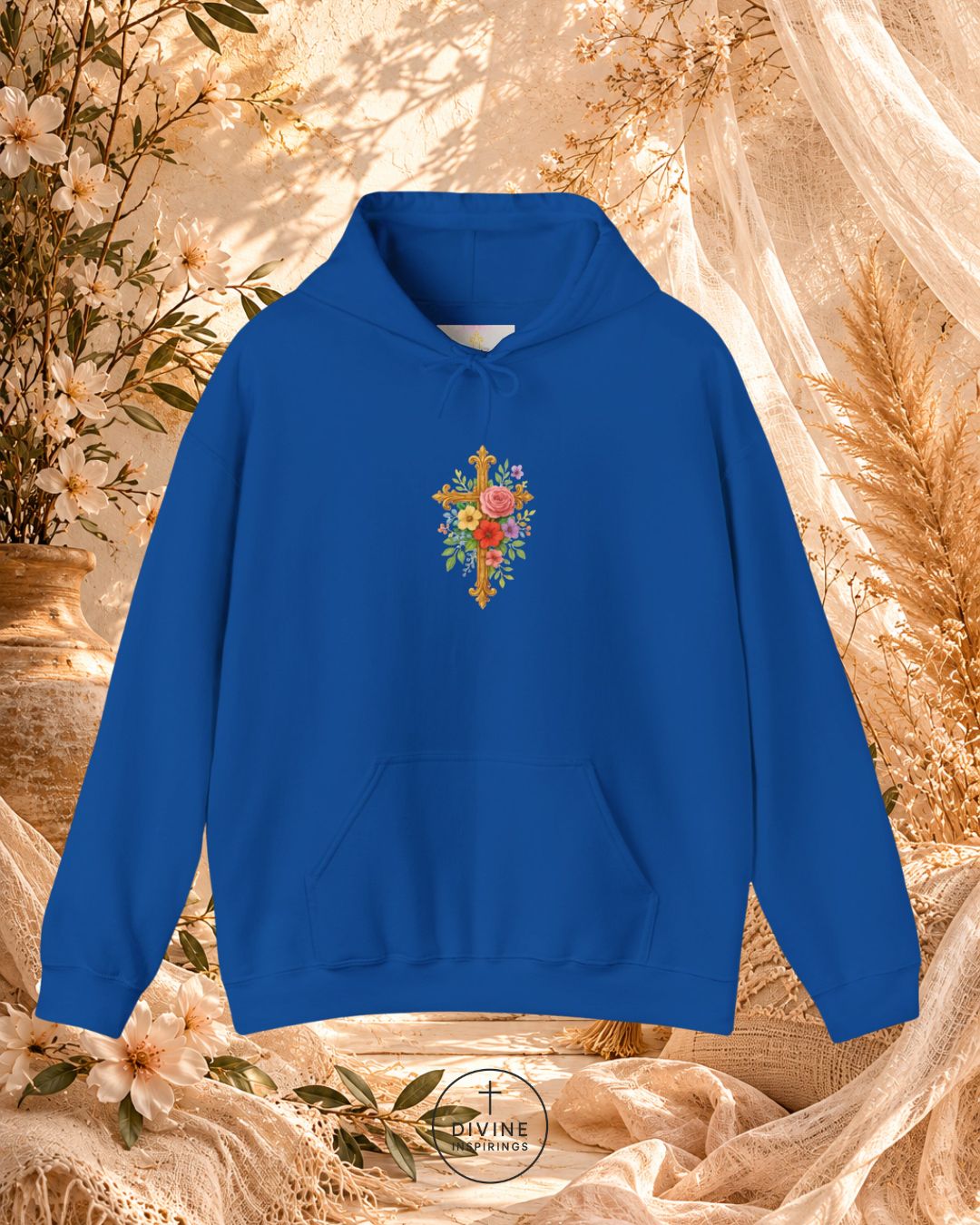 Blue hoodie with floral cross design on a decorative background
