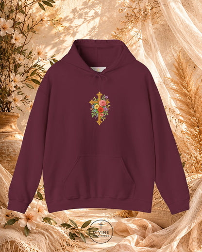 Maroon hoodie with floral cross design on a decorative background