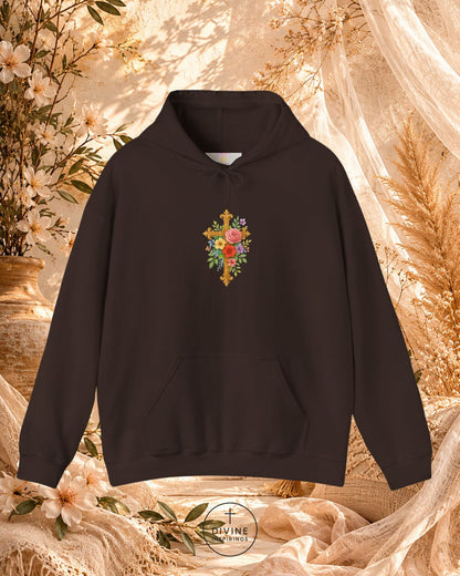 Black hoodie with floral cross design on a decorative background