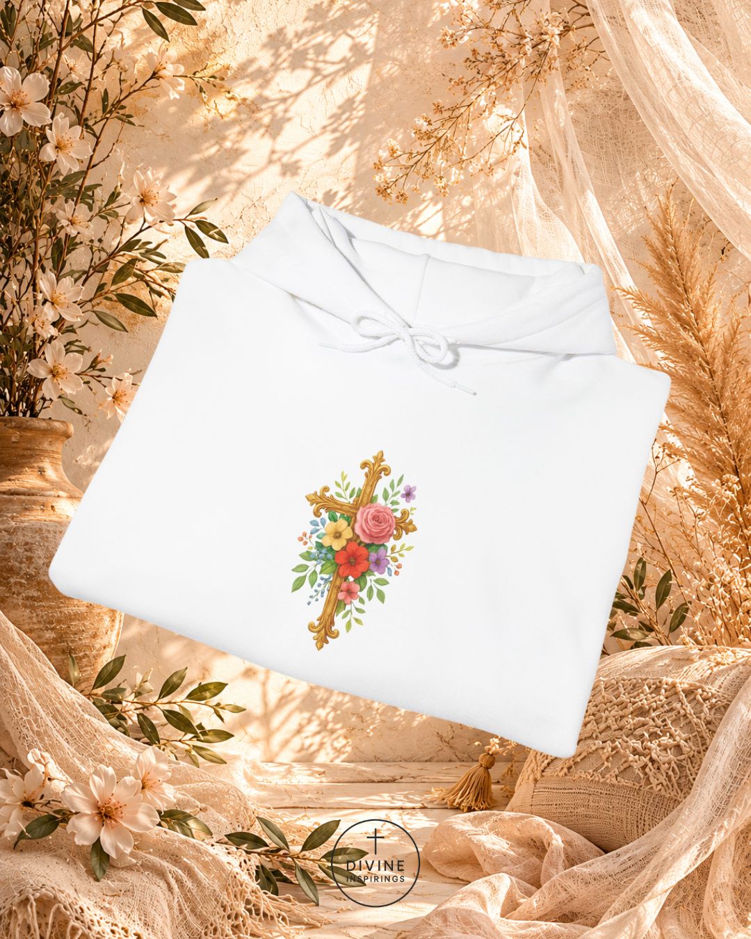 White blouse with floral design on a decorative background with flowers and fabric.