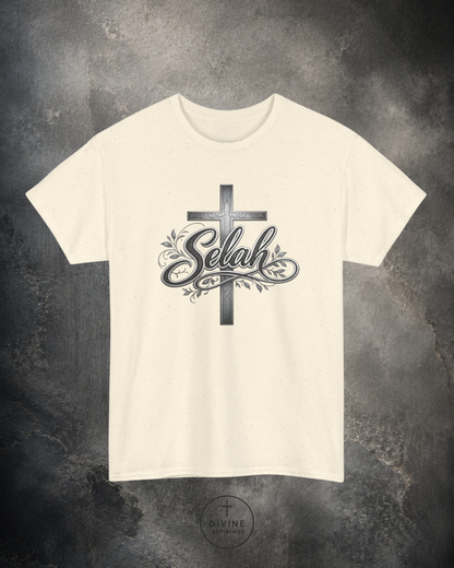 Beige t-shirt with a cross and 'Selah' design on a textured gray background