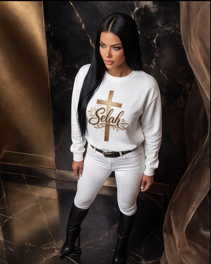 Woman wearing a white sweatshirt with 'Selah' design in a luxurious setting