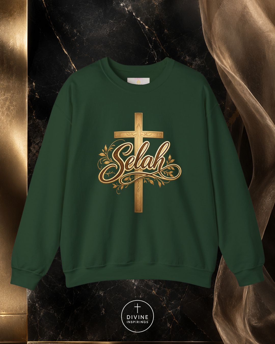 Green sweatshirt with gold cross and 'Selah' text on a dark marble background