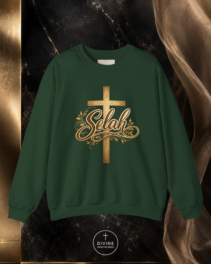 Green sweatshirt with gold cross and 'Selah' text on a dark marble background