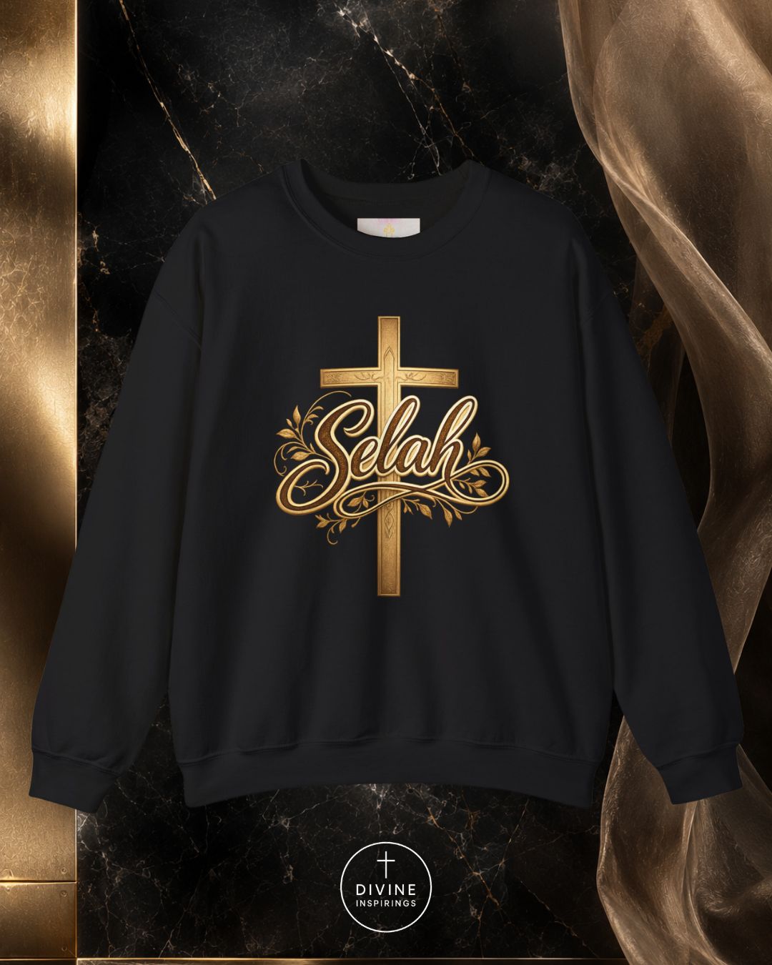 Black sweatshirt with gold cross and 'Selah' text on a dark marble background