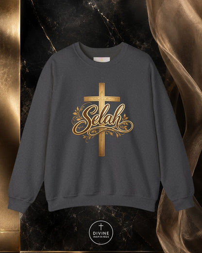 Gray sweatshirt with gold cross and 'Selah' text on a dark marble background