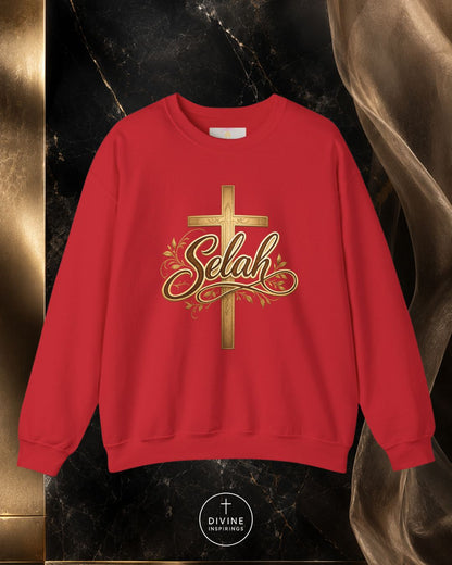 Red sweatshirt with gold cross and 'Selah' text on a dark marble background