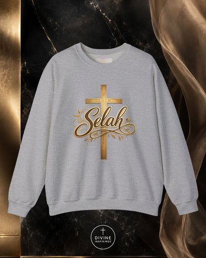 Gray sweatshirt with gold cross and 'Selah' text on a dark marble background