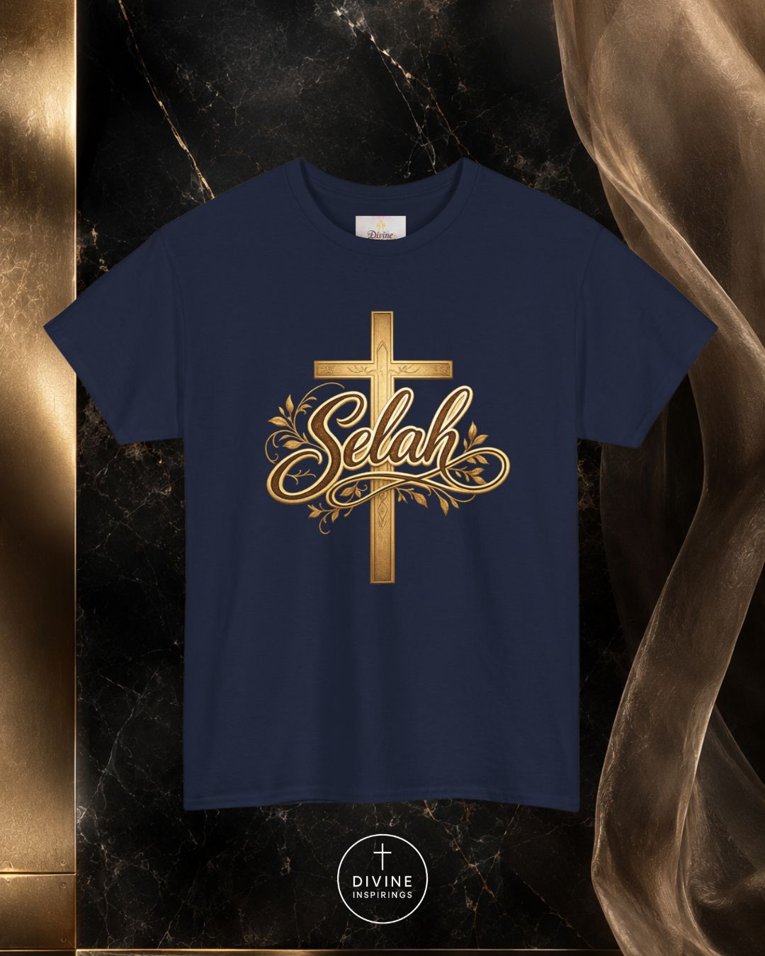 Navy blue t-shirt with gold cross and 'Selah' design on a dark marble background