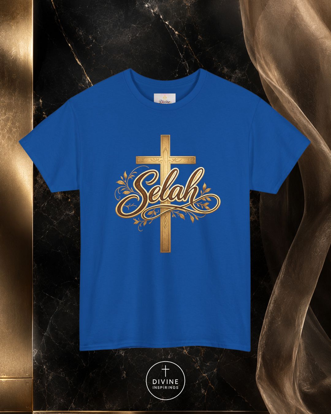 Blue t-shirt with gold cross and 'Selah' design on a dark marble background