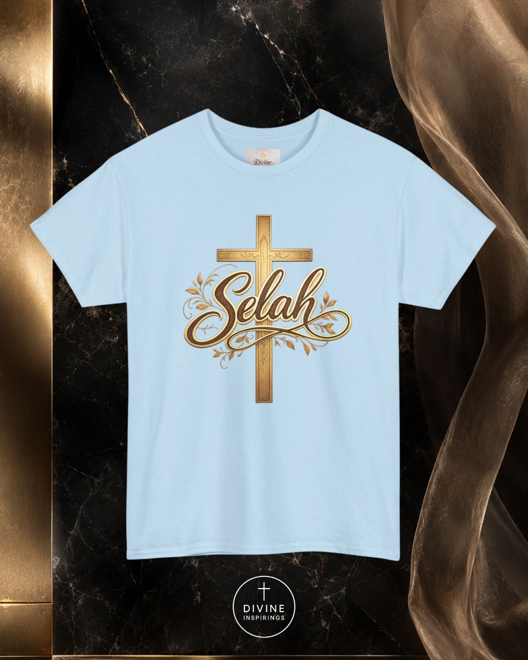 Beige t-shirt with gold cross and 'Selah' text on a dark marble background
