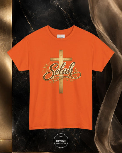 Orange t-shirt with a gold cross and 'Selah' text on a dark marble background