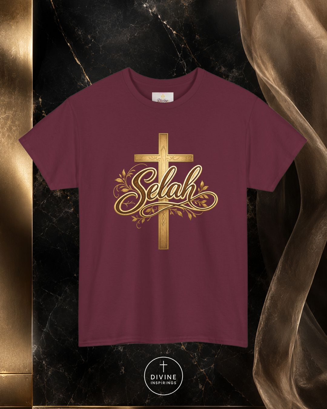 Maroon t-shirt with gold cross and 'Selah' design on a dark marble background