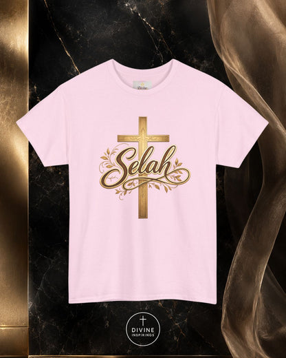 White t-shirt with gold cross and 'Selah' text on a dark marble background