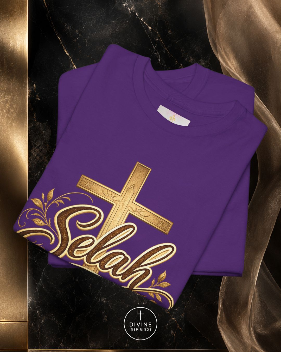Purple t-shirt with gold cross and 'Elah' design on a dark marble background