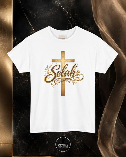 White t-shirt with gold cross and 'Selah' text on a dark marble background