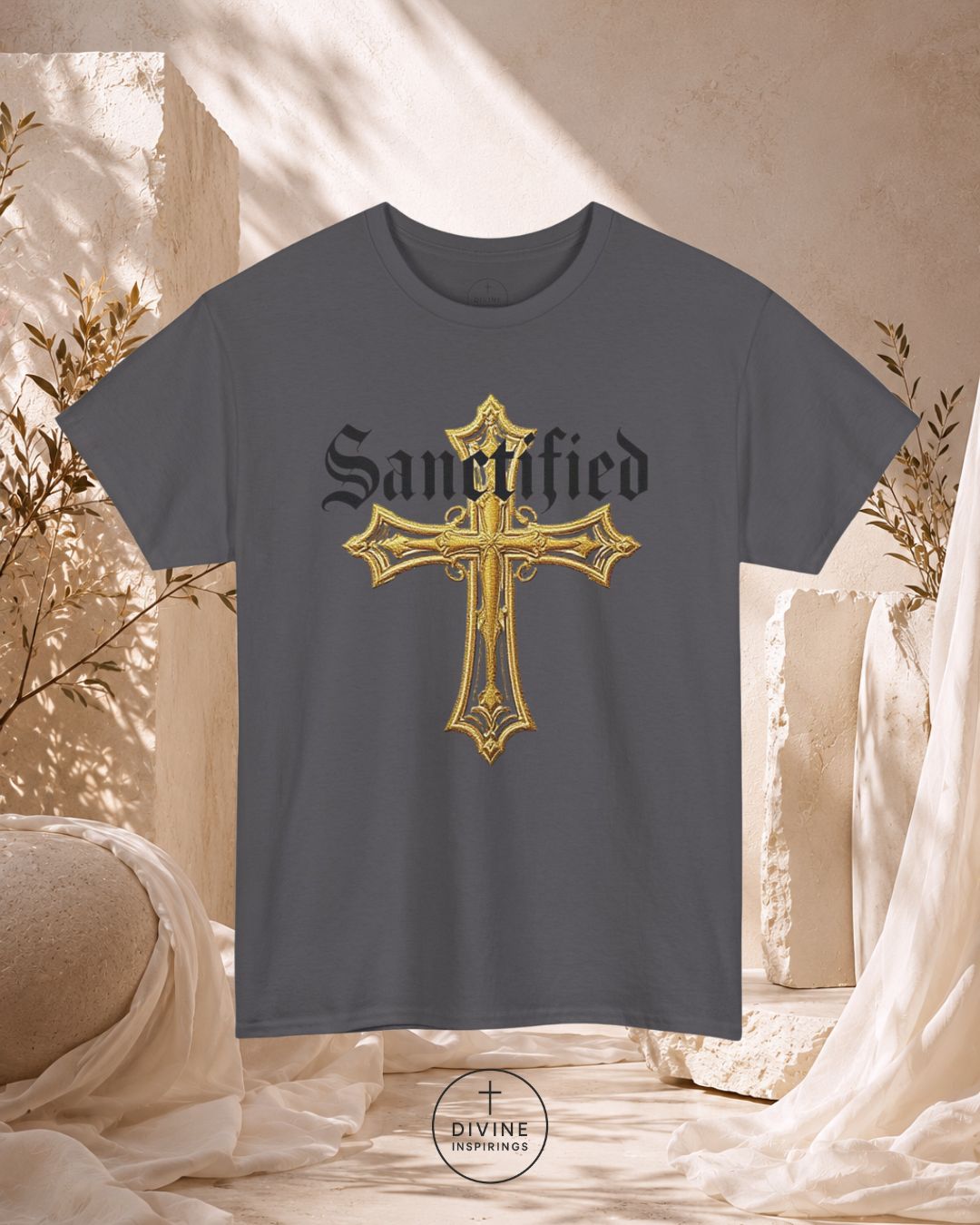Gray t-shirt with gold cross design and 'Sanctified' text on a neutral background