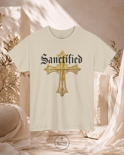 White t-shirt with gold cross design and 'Sanctified' text on a neutral background