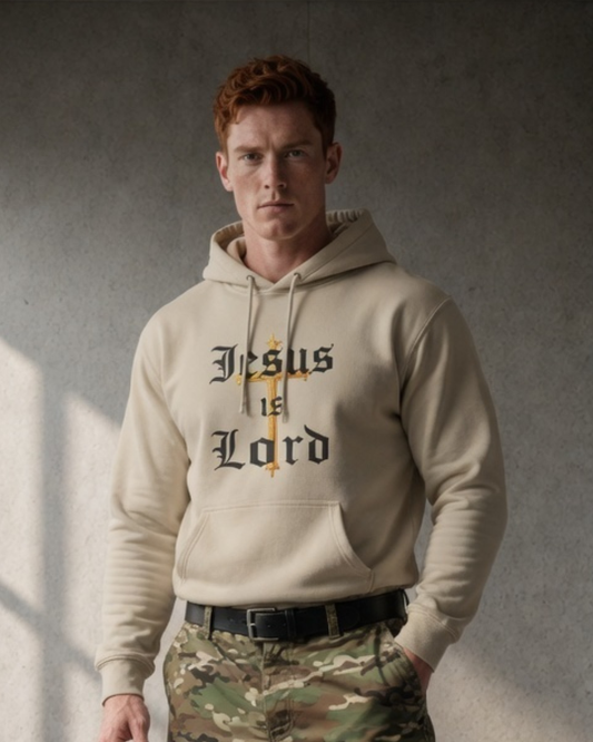 Man wearing a beige hoodie with 'Jesus is Lord' text and camouflage pants against a gray background