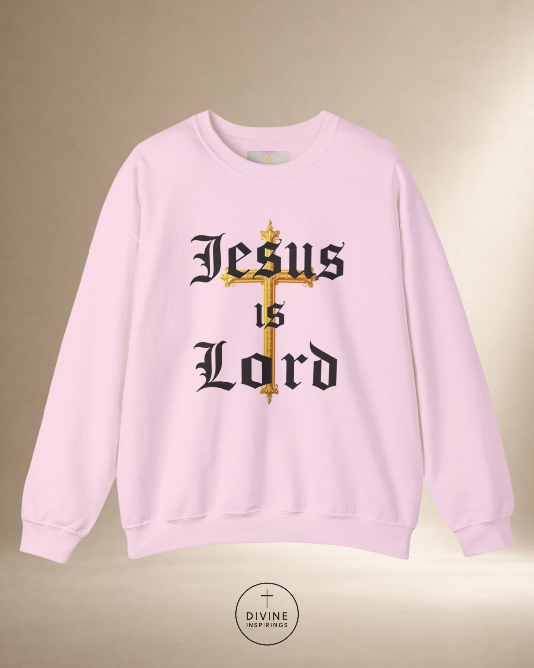 Pink sweatshirt with 'Jesus is Lord' text and cross design on a beige background