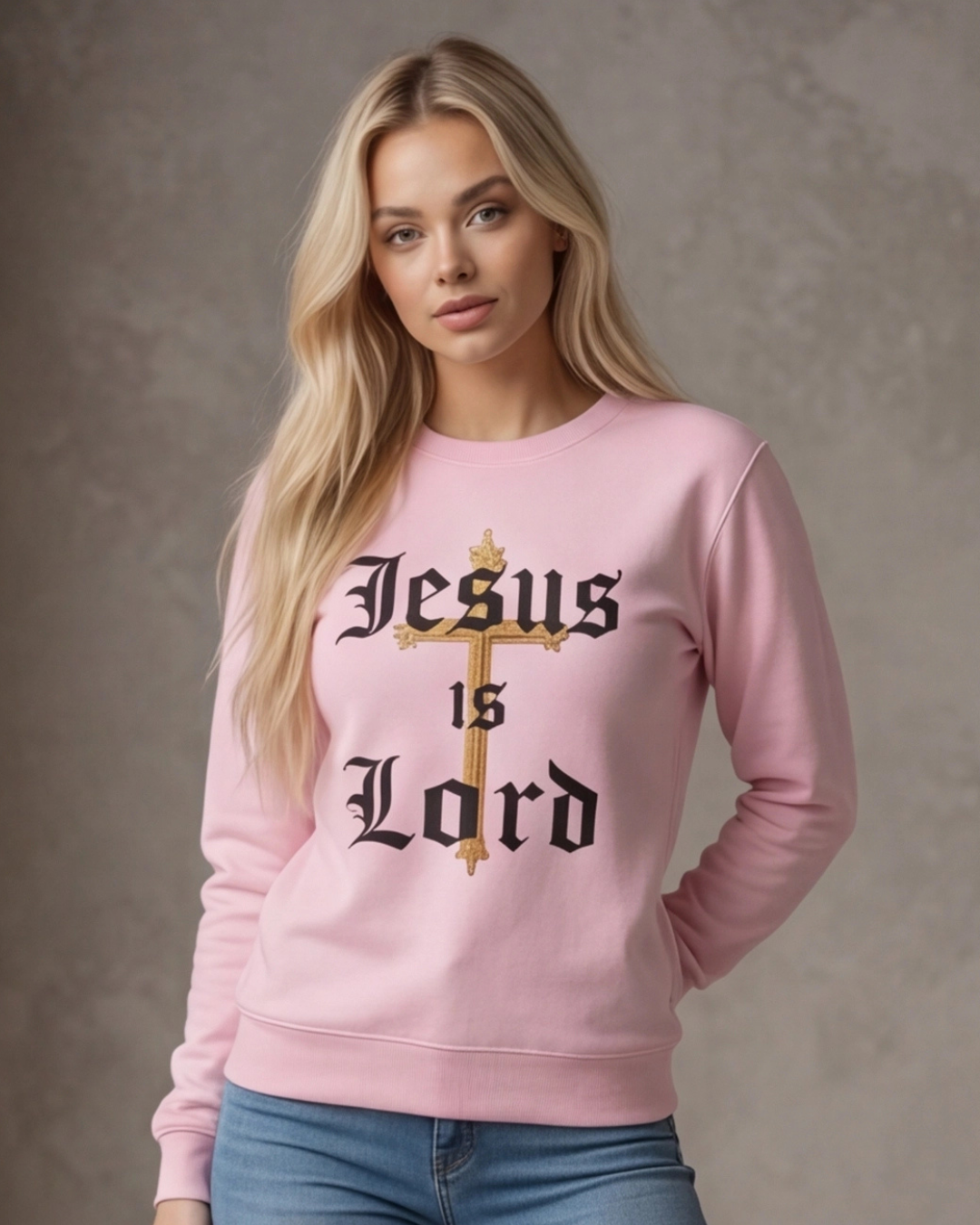 Woman wearing a pink sweatshirt with 'Jesus is Lord' text on a plain background